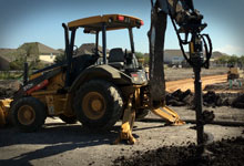 Backhoe with a Digga Auger and Auger Bit.